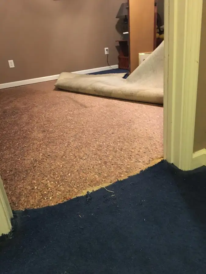 Carpet pad removal revealing water damage during Drying & Dehumidification in Conover